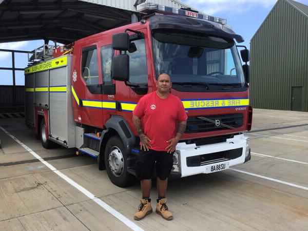 Mitie firefighter standing in front of a fire truck